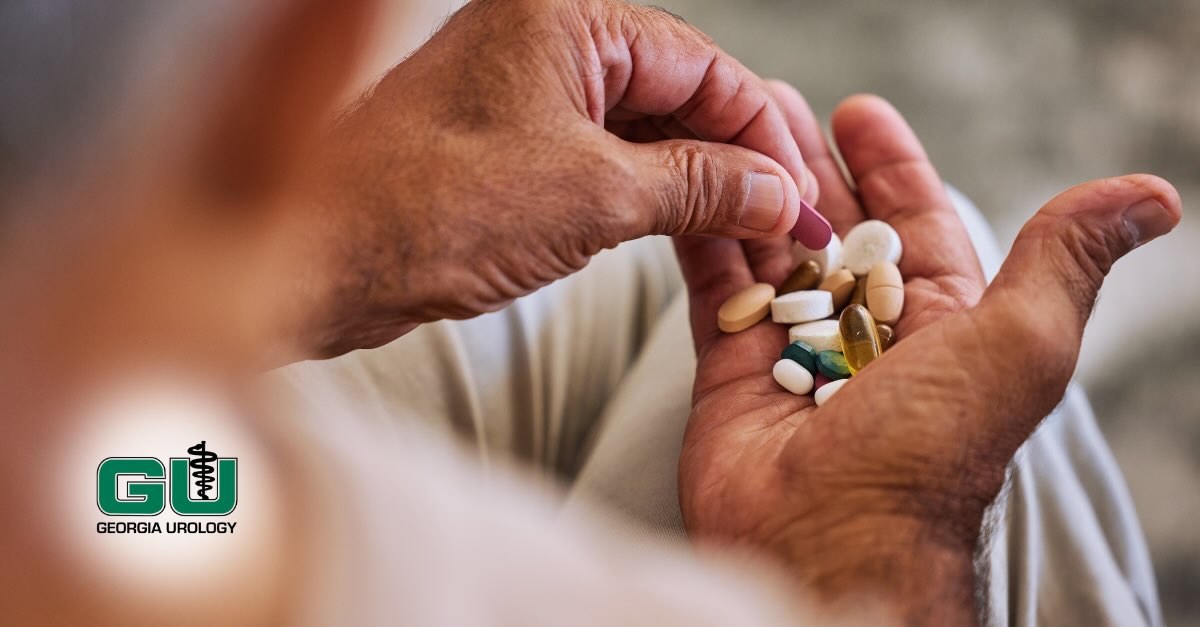 Man holding different supplements in palm of right hand, picking up a pill with left hand