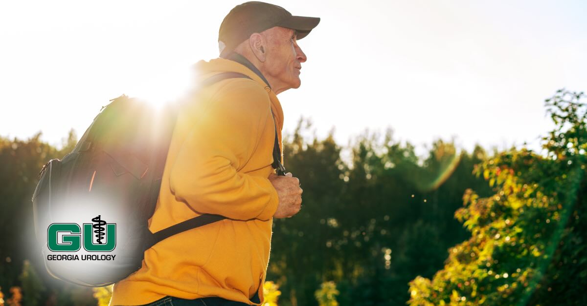 Man in woodsy outdoors walking with backpack on