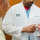 Dr. Anglade showing patient male bladder diagram and pointing to the diagram