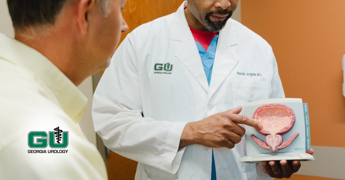 Dr. Anglade showing patient male bladder diagram and pointing to the diagram