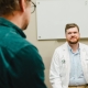 Dr. Kemper having conversation with patient in examination room, both sitting