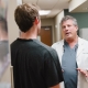 Dr. Kriteman having a discussion with patient in the lobby, patient back turned to camera