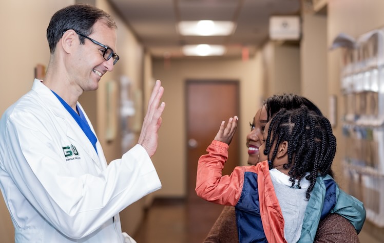 Pediatric Dr High Fiving Young Patient