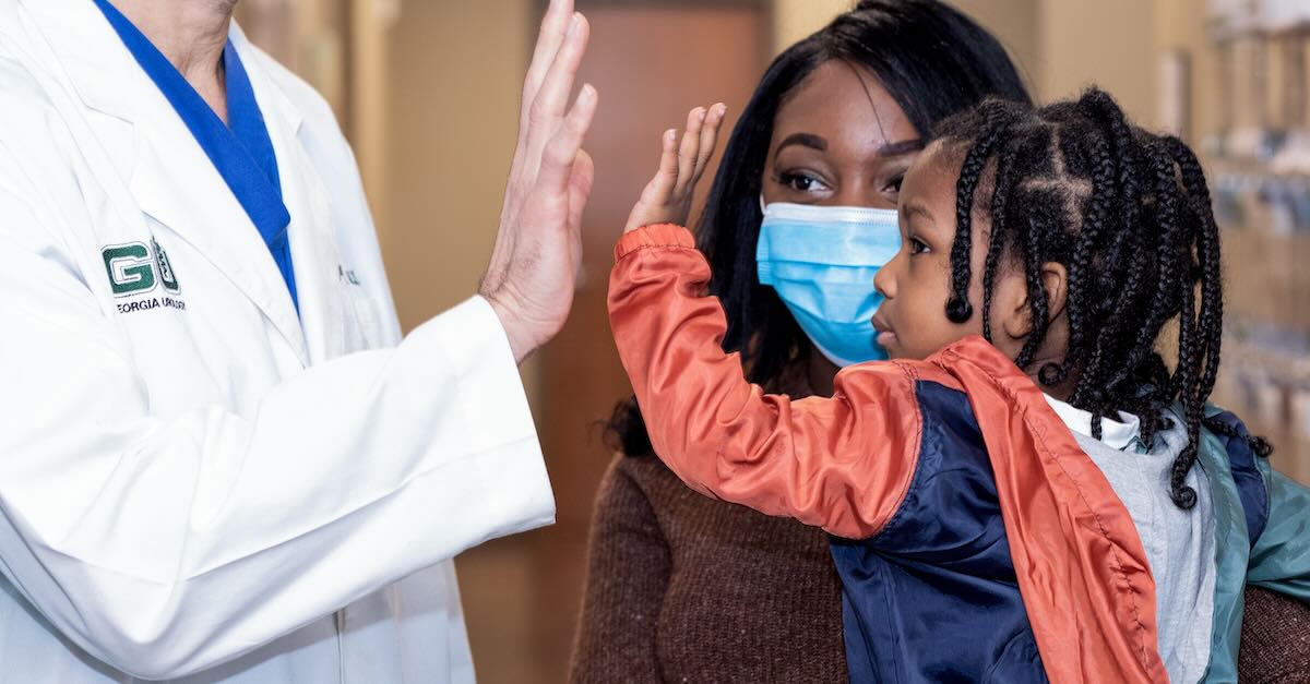 Pediatric Patient High Fiving Georgia Urology Doctor