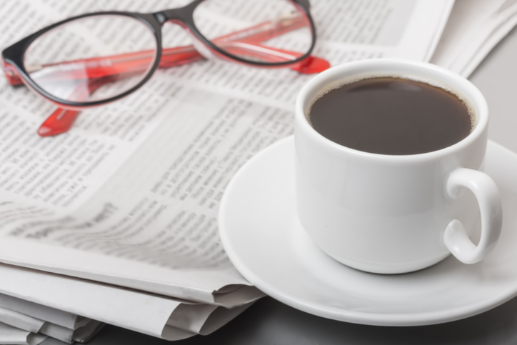 The concept of news. Newspaper on the table, glasses. Coffee break.