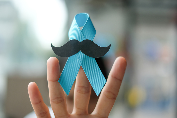 Prostate Cancer Awareness, wonan hand holding light Blue Ribbon with mustache for supporting people living and illness. Men Healthcare and World cancer day concept.